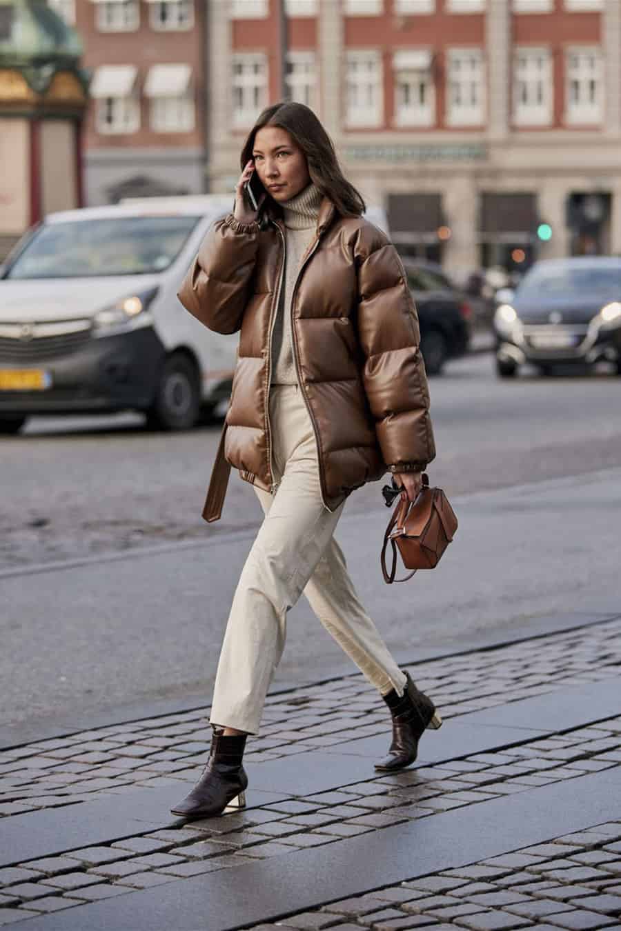 Brown puffer coat with off-white pants